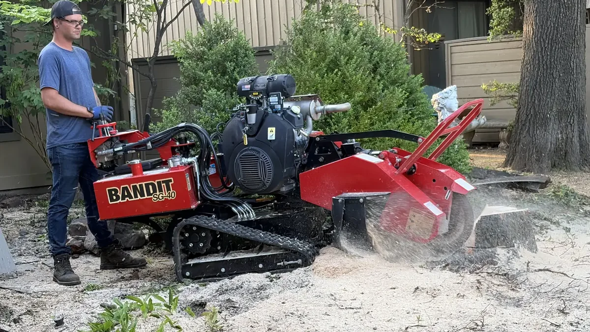 Ironwood Tree Service stump grinder removing a stump in a Tulsa residential yard